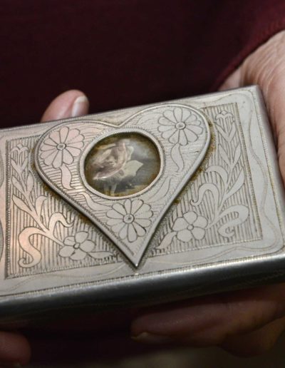 A Russian prisoner made Charles Holcomb this cigarette case from aircraft aluminum in exchange for food. Earlier, the photo of his future wife of 70 years and niece was confiscated inside a matchbook by an interrogator, who returned only the photo.