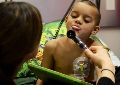 Tae sticks out his tongue when a nurse asks him to open his mouth at UH Rainbow in Cleveland. Nurses frequently check his vital signs during his treatment.