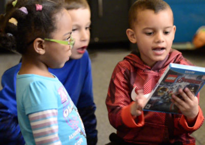 Tae, from right, opens presents with friends Malachi Pavlick, 7, and Kaliyah Boggs, 2. MRI scans in January and February revealed white spots that could be tumor regrowth on Tae's brain.