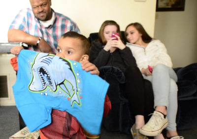 Brandy Lagasse, Tae's mother, takes pictures of him opening his presents. Doctors told the family a second surgery could cause the brain cancer to spread faster through Tae's body.