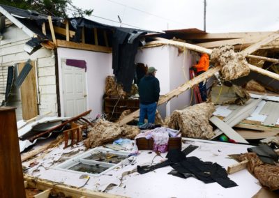 Kevin Weyer looks at the damage an EF 1 tornado did on Nov. 5, 2017 to his in-laws' home where he lives in Townsend Township. Three weeks before the tornado hit, a fire destroyed the family's barn which included five vintage cars and a vintage motorcycle.