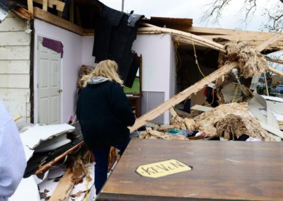 Connie Weyer, right, walks through her home destroyed by a tornado. Every Sunday, the Weyer family eats dinner together. But, on Nov. 5, the family went bowling. "If we were here, my grandkids would have been playing in this room when the tornado hit," Connie said.