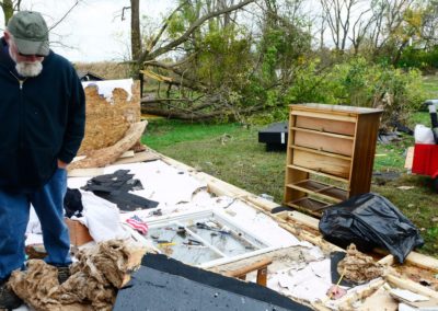 Kevin Weyer looks at the damage an EF 1 tornado did on Nov. 5, 2017 to his in-laws' home where he lives in Townsend Township. Three weeks before the tornado hit, a fire destroyed the family's barn which included five vintage cars and a vintage motorcycle.