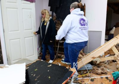 Connie Weyer, left, walks through her home destroyed by a tornado. Every Sunday, the Weyer family eats dinner together. But, on Nov. 5, the family went bowling. "If we were here, my grandkids would have been playing in this room when the tornado hit," Connie said.