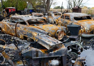 Three weeks before the Oct. 5 tornado, a fire burned down the Weyer's 95’ x 45’ pole barn. Kevin Weyer walks through the ashy, burnt out shells of vintage cars that sit uncovered amid the ruins of their barn. Lost in the fire was an antique ’76 bicentennial liberator edition Harley Davidson motorcycle, and antique cars that included a ’50 Mercury, ’56 Ford, ’48 Ford, ’50 Ford, and ’67 Mustang convertible owned by his in-laws who own the house.