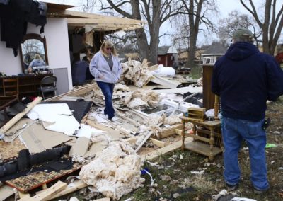 Connie Weyer, left, and her husband, Kevin, look at the damage an EF 1 tornado did on Nov. 5, 2017 to Connie's parents home where they live in Townsend Township. Three weeks before the tornado hit, a fire destroyed the family's barn which included five vintage cars and a vintage motorcycle.