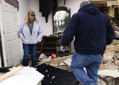 Connie Weyer, left, and her husband, Kevin, look at the damage an EF 1 tornado did on Nov. 5, 2017 to Connie's parents home where they live in Townsend Township. A fire three weeks before destroyed the barn including five vintage cars and a vintage motorcycle.