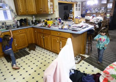 Five-year-old Becca Weyer, left, and her sister, Kaydee, 3, run through the house and play. They used to run in a circle through the section of the house that was blown away by the tornado. “I thank the Lord that we weren’t home,” their grandmother, Connie Weyer, said. “They would have been in that.”